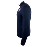 The USA Rugby 25 Travel 3D Full-Zip Top by Macron in navy features a high collar, USA Rugby 25 chest logo, and a zippered side pocket, shown here from the side.