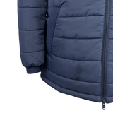 Close-up of the USA Rugby 25 Padded Jacket by Macron in navy blue, made from rain-resistant fabric, highlighting the right sleeve, pocket, and front zipper.