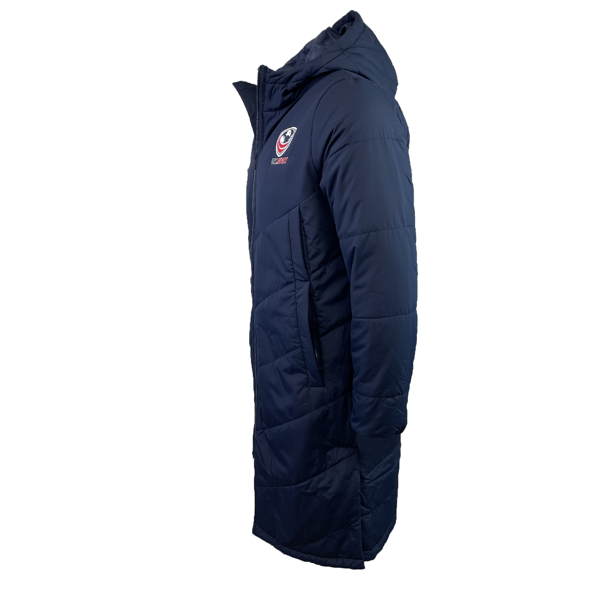The USA Rugby 25 Padded Bench Jacket by Macron is a navy blue hooded coat with a quilted design, made from water-resistant fabric and featuring the Macron logo on the chest, shown in a side profile view.