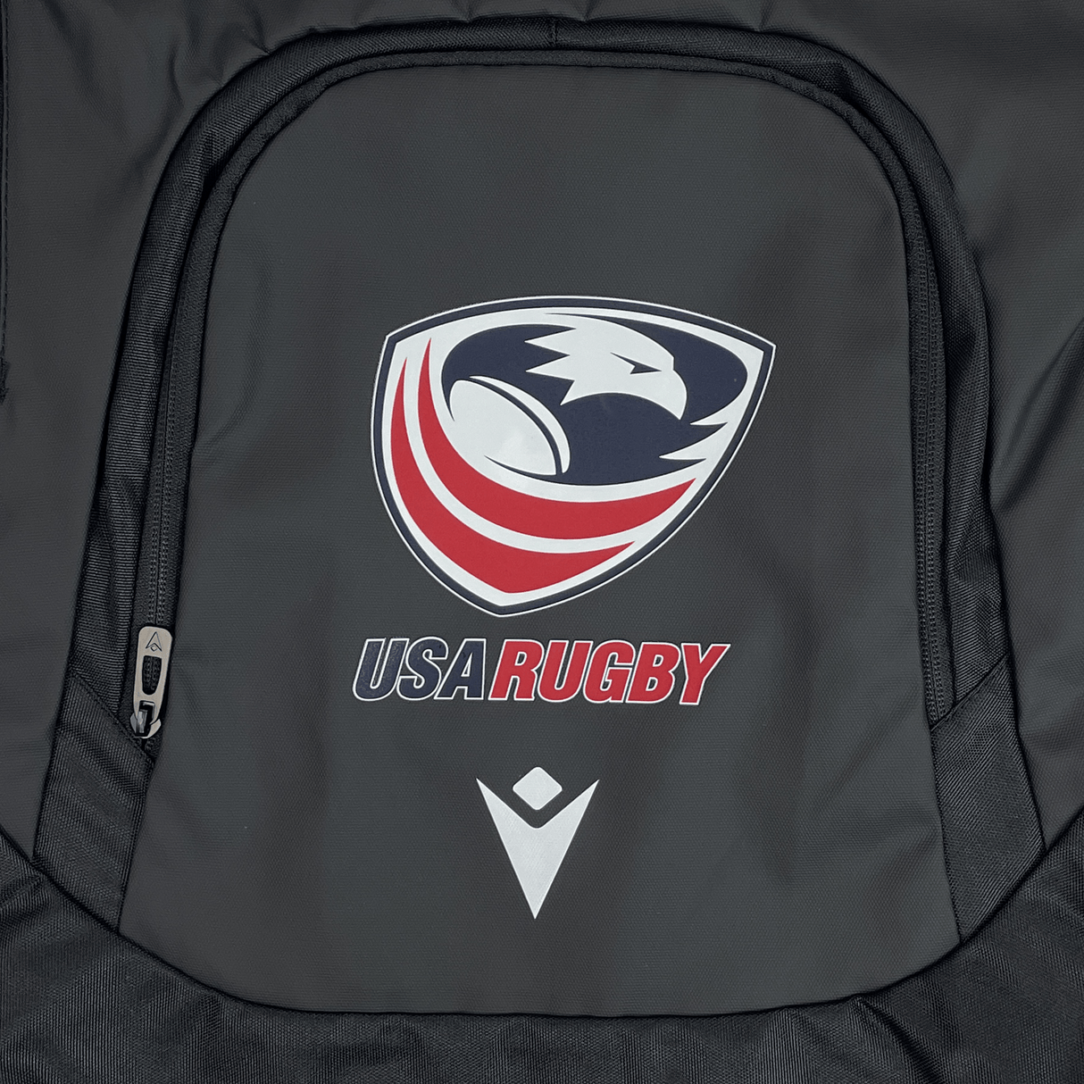 The USA Rugby 25 Gymsack by Macron is a black waterproof bag featuring a stylized eagle, red stripes, "USA Rugby" text, and the Macron logo below.