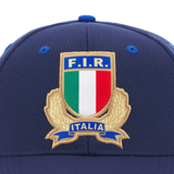 Close-up of the Italy 25/26 Supporters Cap by Macron, featuring the Italian Rugby Federation crest with "F.I.R." and "Italia" above a tricolor shield.
