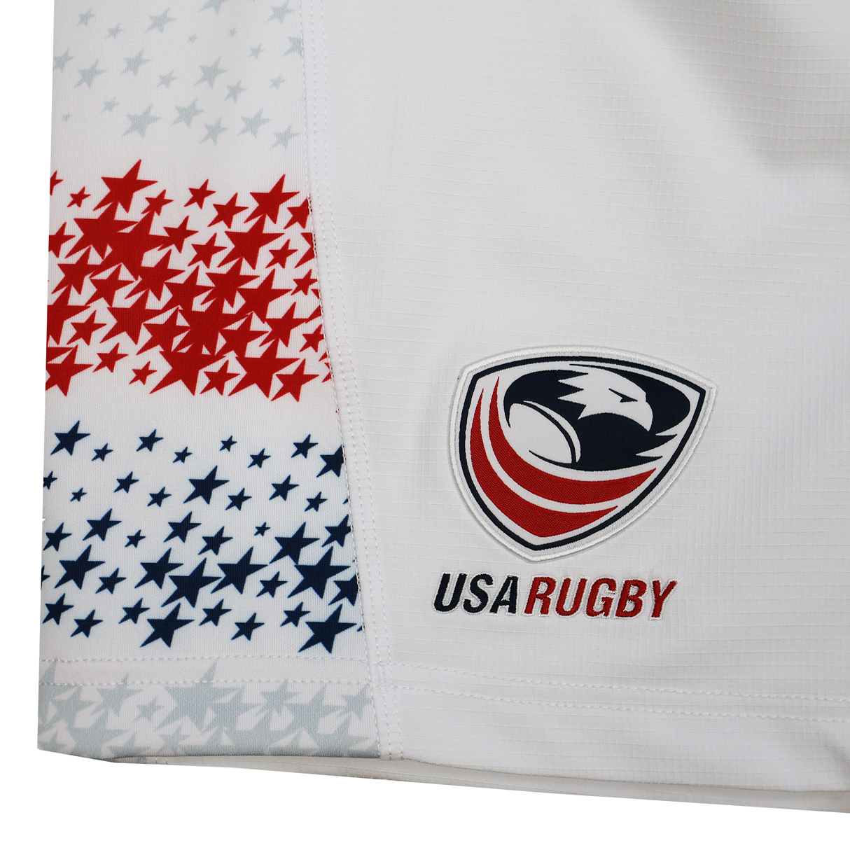 Pair the White USA Rugby jersey, featuring red and blue stars and the eagle logo, with USA Rugby 25/26 Home Shorts by Macron for lightweight breathability and ultimate comfort on or off the field.
