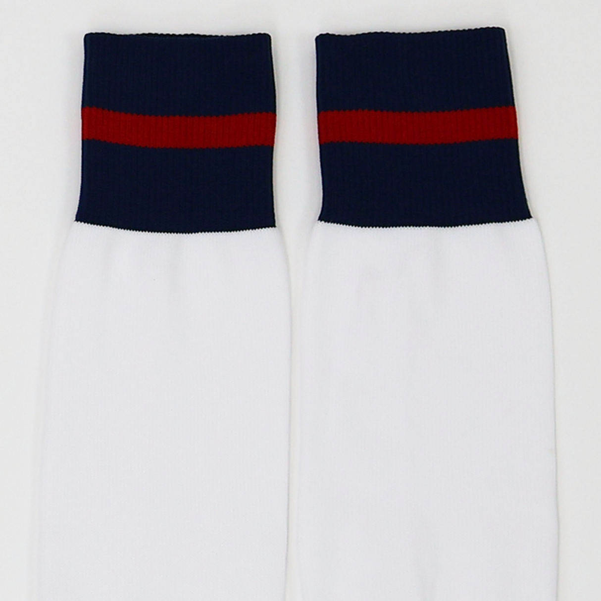 The USA Rugby M25/26 Home Socks by Macron are white performance socks featuring navy blue cuffs and a red horizontal stripe near the top, designed for comfort and durability.