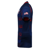 Side view of the USA Rugby 25/26 Away Body Fit Match Jersey by Macron—a navy, form-fitting rugby jersey with red and blue pixel patterns, American flag on the sleeve, and chest logo—designed for high performance.