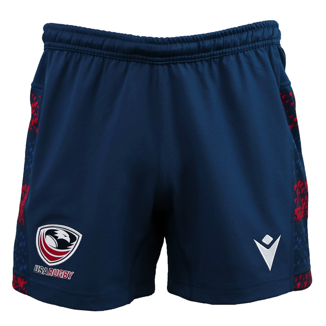 The USA Rugby 25/26 Away Shorts by Macron are navy blue moisture-wicking shorts with a USA Rugby logo on the left leg, a white Macron logo on the right, and red side patterns.