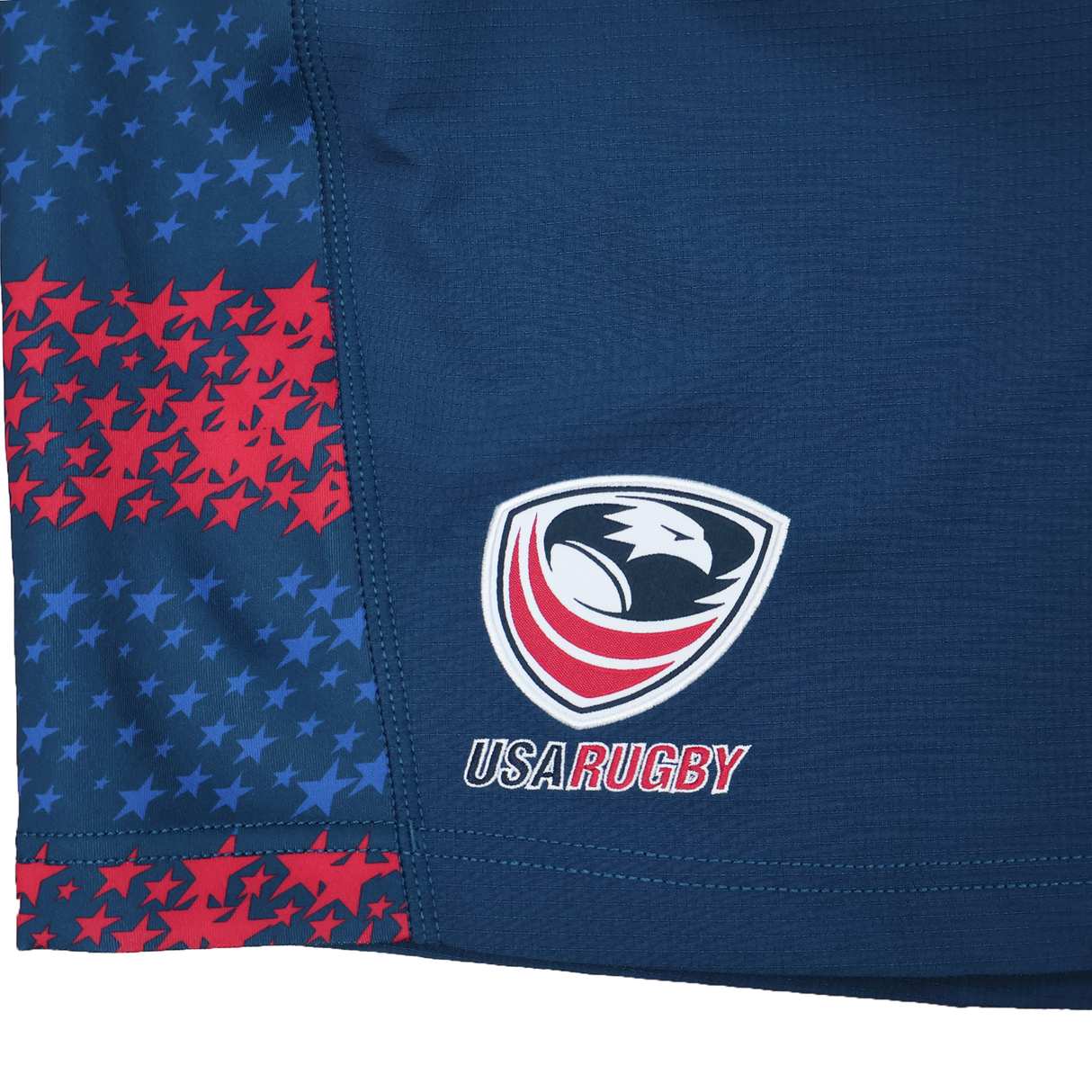 Close-up of a blue USA Rugby uniform with the eagle logo and star pattern, paired with the USA Rugby 25/26 Away Shorts by Macron—moisture-wicking rugby shorts from Macron.