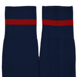 The USA Rugby M25/26 Away Socks by Macron are navy blue with a bold red horizontal stripe near the top.