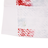 The Youth USA Rugby 25/26 Home Replica Jersey by Macron features white fabric with red and gray stars, visible stitching, and an "Eco" label near the hem, combining sporty style with everyday comfort.