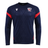 The USA Rugby 25/26 LS Training Poly Shirt by Macron features a navy design with diamond pattern, red sleeve accents, and the USA Rugby logo—an ideal long sleeve training shirt for both practice and casual wear.