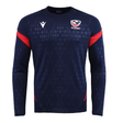 The USA Rugby 25/26 LS Training Poly Shirt by Macron features a navy design with diamond pattern, red sleeve accents, and the USA Rugby logo—an ideal long sleeve training shirt for both practice and casual wear.