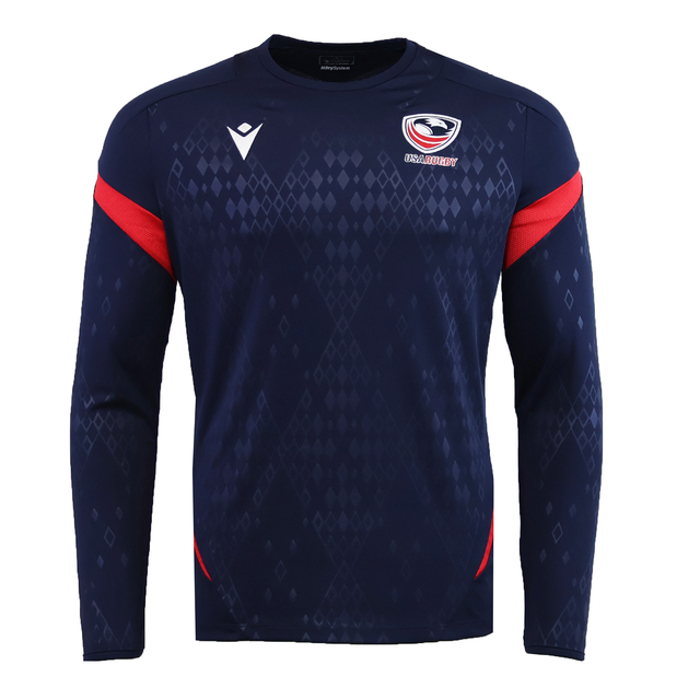 The USA Rugby 25/26 LS Training Poly Shirt by Macron features a navy design with diamond pattern, red sleeve accents, and the USA Rugby logo—an ideal long sleeve training shirt for both practice and casual wear.