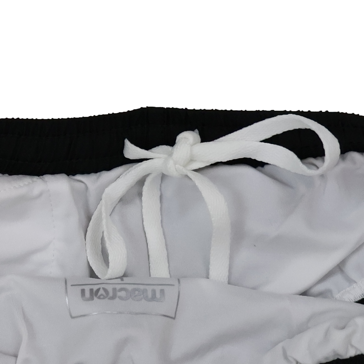 Close-up of the waistband on Women's USA Rugby 25/26 Athletics Shorts by Macron, featuring a white drawstring bow and visible Macron label—ideal for quick-dry training or as official USA Rugby gear.