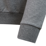 Close-up of the sleeve and hem of the USA Rugby 25/26 Player Travel Sweatshirt by Macron, highlighting the ribbed cuff and waistband against a white background.