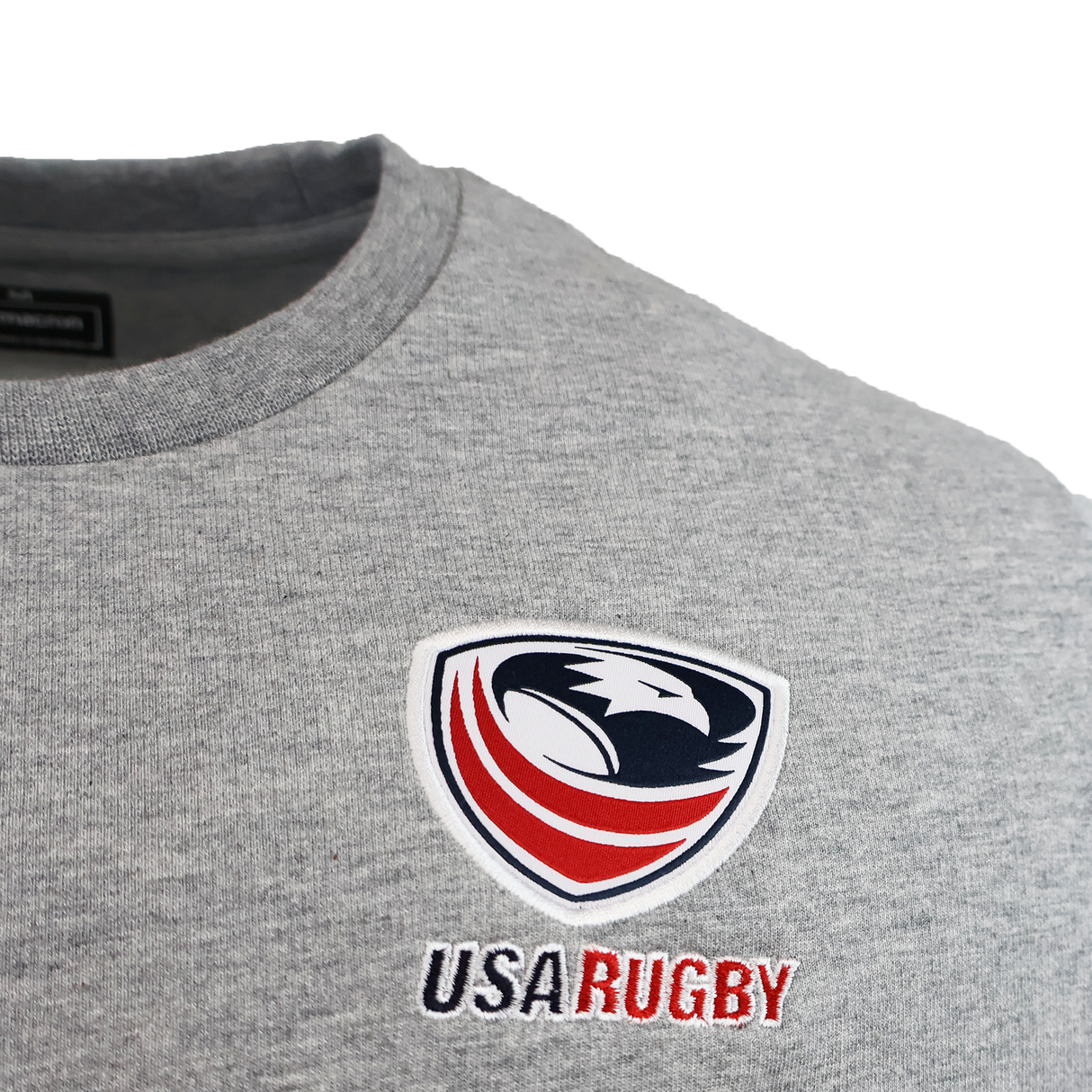 Close-up of the USA Rugby 25/26 Player Travel Sweatshirt by Macron in gray, featuring the official logo and "USA Rugby" embroidery. Perfect for fans and athletes as a stylish player travel sweatshirt.
