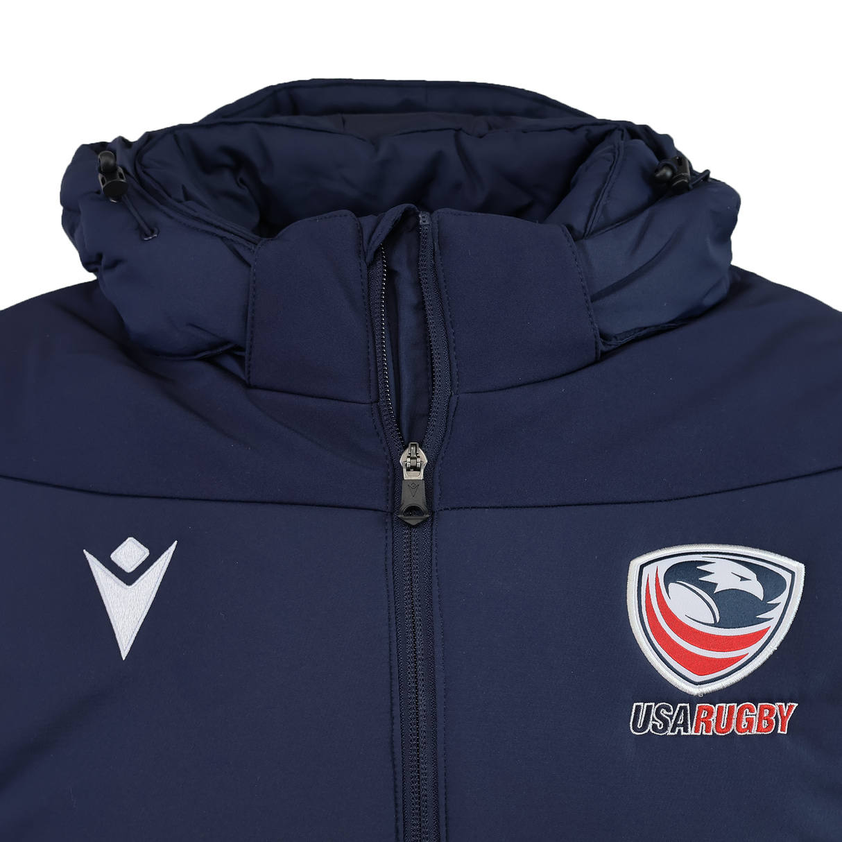 The USA Rugby 25/26 Padded Jacket by Macron is a navy blue zip-up with padding, featuring the USA Rugby eagle logo on the right chest and a white Macron logo on the left.