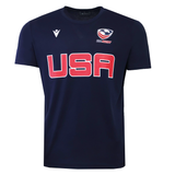 The USA Rugby M25/26 Leisure Shirt by Macron features "USA" in bold red letters, a white USA Rugby logo, the USAR M25/26 insignia, and a white Macron logo on the front.