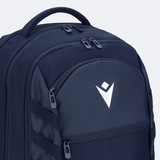 The USA Rugby 25/26 Athleisure Backpack by Macron is a spacious navy blue backpack with multiple zippered compartments and a white geometric logo on the front pocket, ideal for athleisure or daily use.