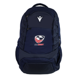The USA Rugby 25/26 Athleisure Backpack by Macron is a navy blue bag with the USA Rugby logo and a white geometric front emblem, offering multiple zippered compartments and mesh side pockets for organized storage.