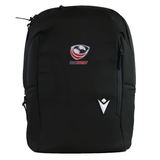 The USA Rugby 25/26 Staff Backpack by Macron is a black ergonomic backpack with the USA Rugby and Macron logos on the front, shown against a white background.