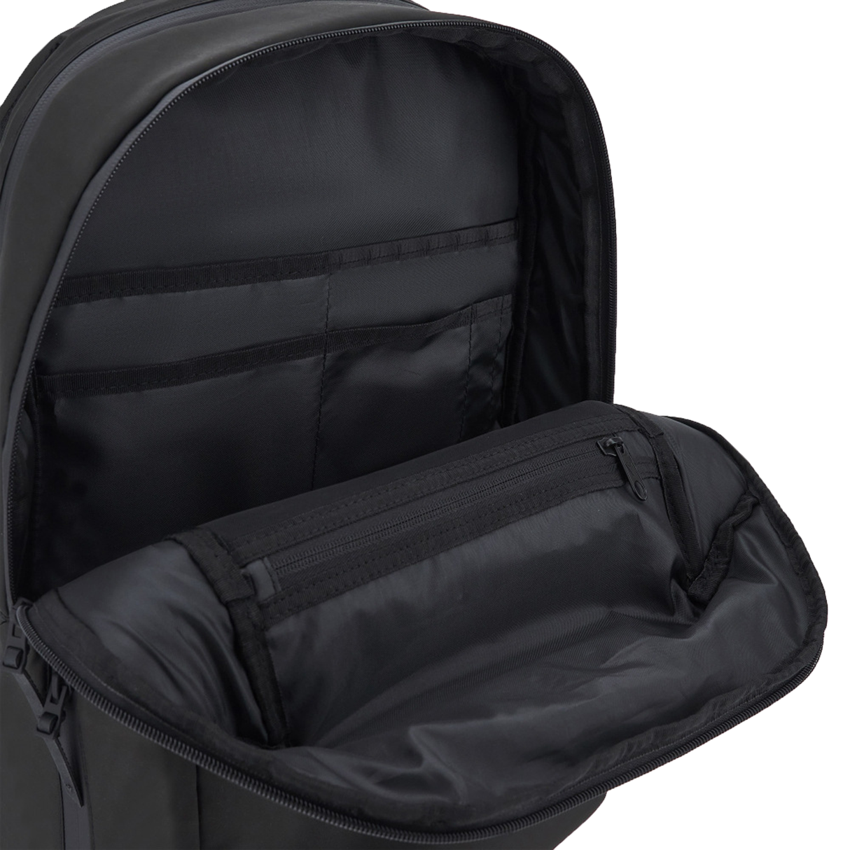 A close-up of the open USA Rugby 25/26 Staff Backpack by Macron displays its interior compartments and zippered pocket.