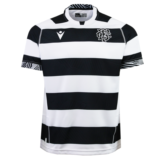 The Barbarians 25/26 Replica Home Jersey by Macron features black and white horizontal stripes, short sleeves, a team logo on the left chest, and patterned sleeve cuffs.