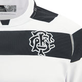 Close-up of the Barbarians 25/26 Replica Home Jersey by Macron—a white rugby jersey featuring a black horizontal stripe and embroidered interlocking chest logo, capturing the authentic Barbarians look.