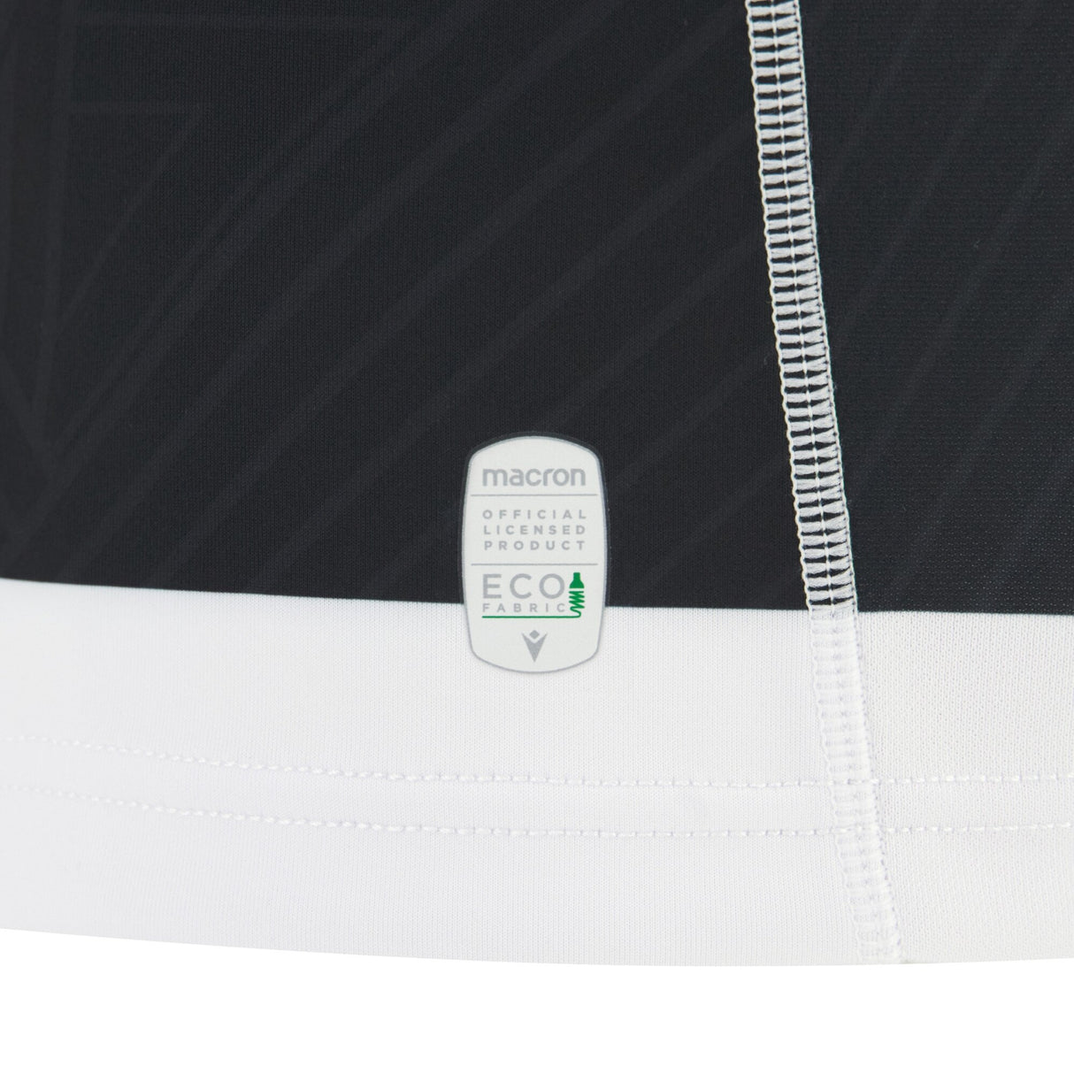 Close-up of the Barbarians 25/26 Replica Home Jersey by Macron, featuring visible stitching and a “Macron official licensed product eco fabric” label that highlights the quality details of this authentic jersey.