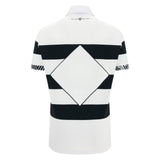 The Barbarians 25/26 Cotton Short Sleeve Home Jersey by Macron features black horizontal stripes and a large black diamond pattern on the back, inspired by the classic Barbarians home design.