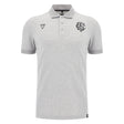 The Barbarians 25/26 Player Travel Polo by Macron is a light grey short-sleeve polo with a three-button placket, black embroidered chest logos, and a classic collar.