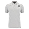 The Barbarians 25/26 Player Travel Polo by Macron is a light grey short-sleeve polo with a three-button placket, black embroidered chest logos, and a classic collar.