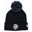 The Barbarians 25/26 Pom-Pom Beanie by Macron features a black knit design with a white embroidered monogram logo and emblem on the cuff, inspired by the classic Barbarians beanie.