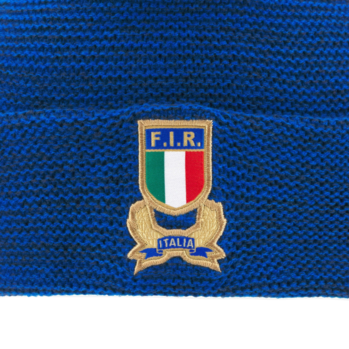 Show your Italy pride with the Italy 25/26 Supporters Pom-Pom Beanie by Macron—blue knit, embroidered "F.I.R." badge and Italian flag colors, "Italia" label at the base. Perfect for dedicated fans!.