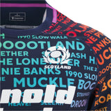 The Scotland 25/26 Rainbow Training Jersey by Macron features vibrant Scottish words and phrases with the team logo, highlighted in a colorful close-up design.