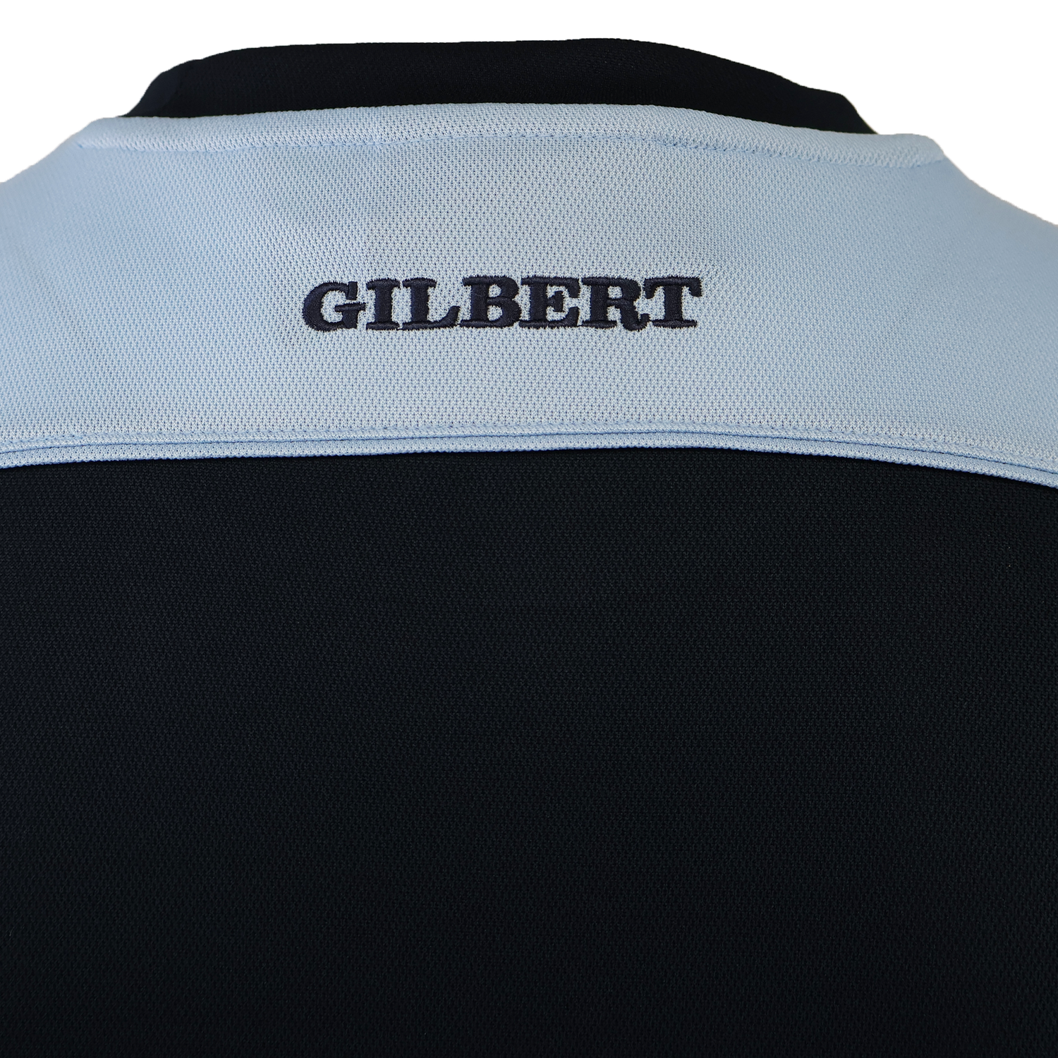 Close-up of the Gilbert Photon Training Tee’s back, showing "GILBERT" embroidered in black on a light blue panel above black, designed ergonomically with moisture-wicking fabric for comfort.