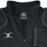 The Gilbert Quest 2 1/4 Zip Fleece Top, a black athletic pullover with a high collar and logo on the chest, offers style and mobility. Crafted from micro-polyester for comfort, it includes folded sleeves and medium sizing.