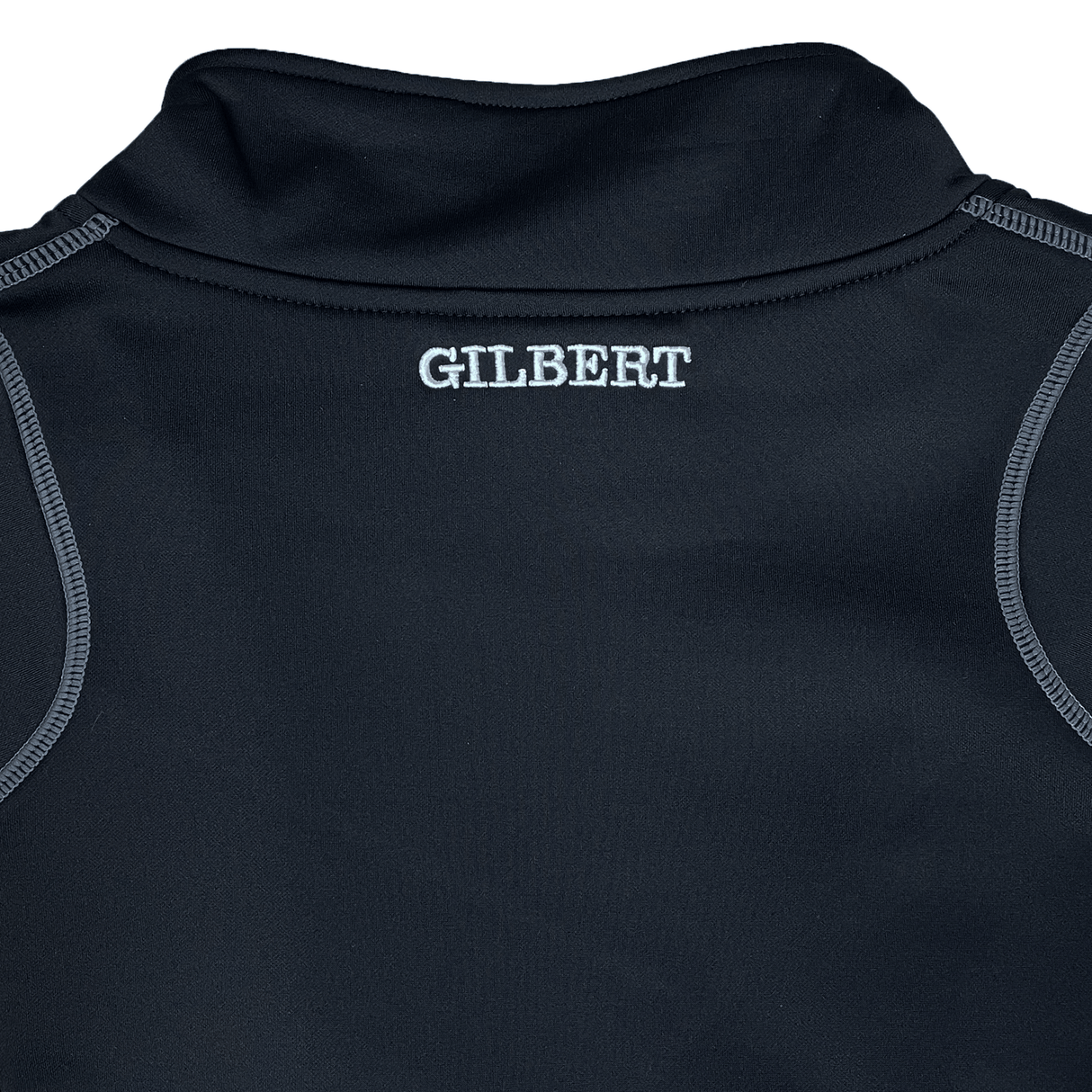 The back of a black Gilbert Quest 2 1/4 Zip Fleece Top features "GILBERT" in white near the collar, crafted from micro-polyester for enhanced mobility.