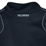 The back of a black Gilbert Quest 2 1/4 Zip Fleece Top features "GILBERT" in white near the collar, crafted from micro-polyester for enhanced mobility.