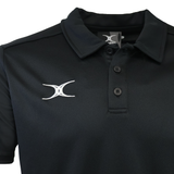The Gilbert Photon II Polo is a black, short-sleeve collared shirt with three buttons and a white embroidered Gilbert logo on the left chest, made from lightweight, moisture-wicking fabric for all-day comfort.