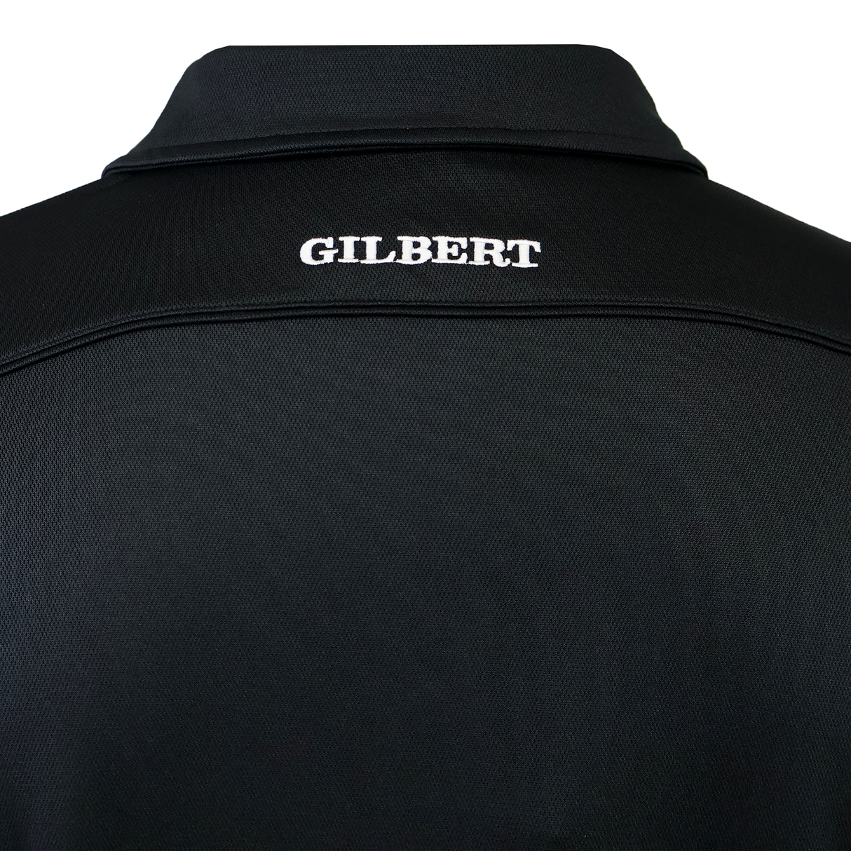Back view of the Gilbert Photon II Polo, a black shirt made from lightweight fabric with "GILBERT" embroidered in white on the upper back.