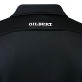 Back view of the Gilbert Photon II Polo, a black shirt made from lightweight fabric with "GILBERT" embroidered in white on the upper back.