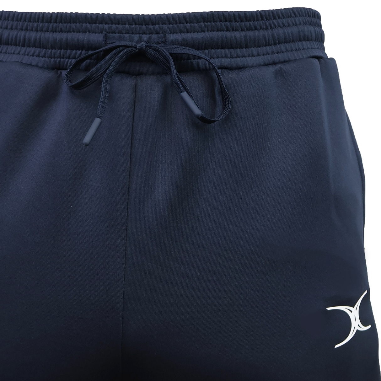 Close-up of navy blue Gilbert GTS Training Pants by Gilbert, featuring an elastic waistband, drawstring, and a white crescent logo on the left leg—ideal for rugby training.