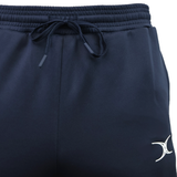 Close-up of navy blue Gilbert GTS Training Pants by Gilbert, featuring an elastic waistband, drawstring, and a white crescent logo on the left leg—ideal for rugby training.