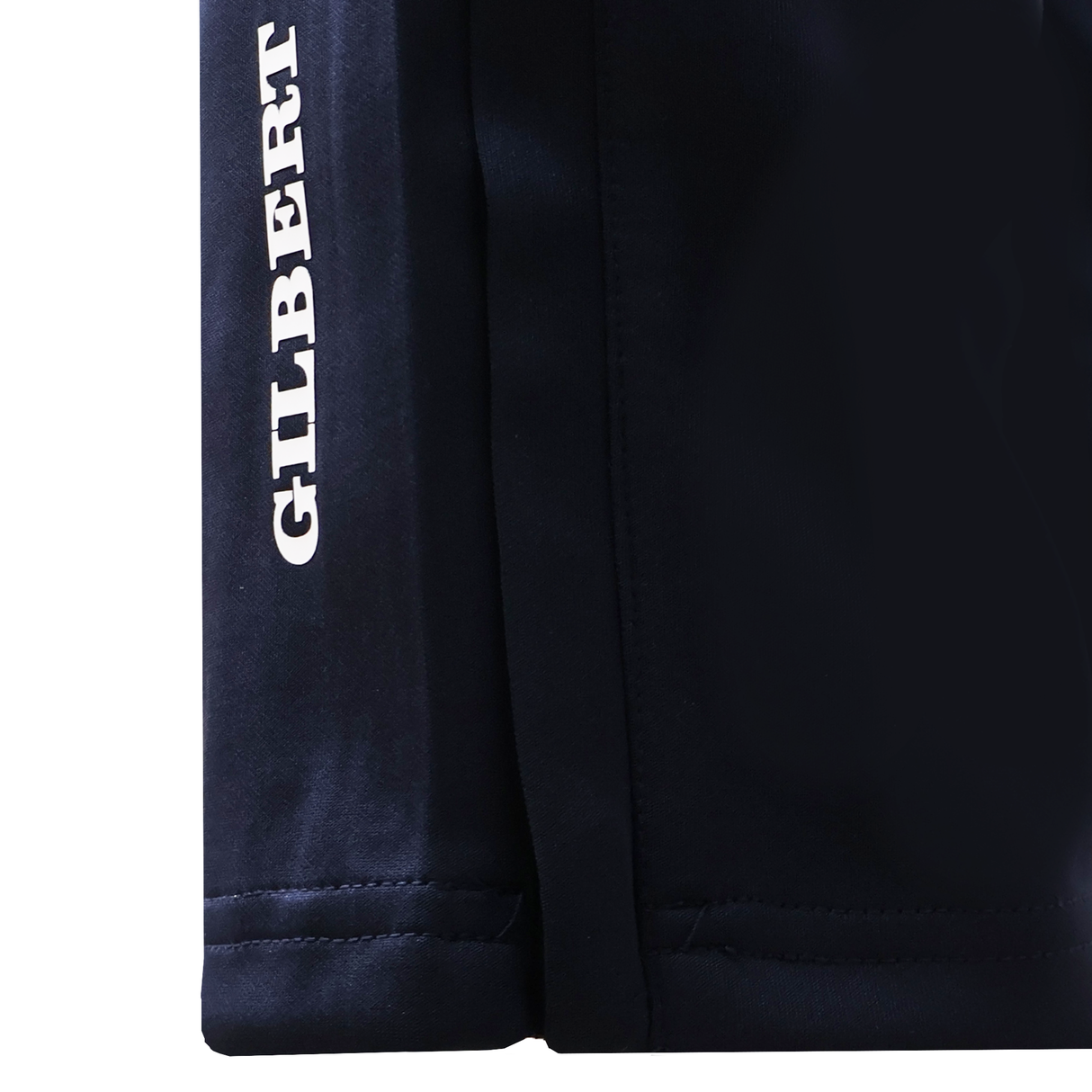 Close-up of the lower section of Gilbert GTS Training Pants by Gilbert, featuring "GILBERT" printed vertically in white text on the left side.