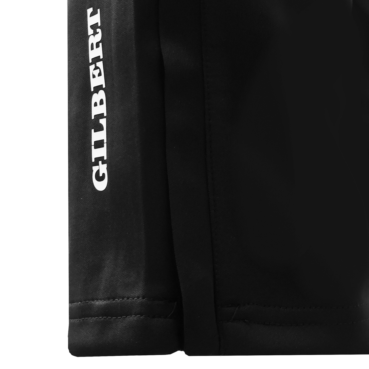 Close-up of black Gilbert GTS Training Pants featuring "GILBERT" printed vertically in white along the seam, perfect for rugby training.