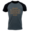 A dark gray and black raglan Gilbert Rugby 200 Year Anniversary Leisure Shirt by Gilbert features the text "Gilbert Rugby 1823" in bold gold letters on the front, celebrating its rich rugby history.