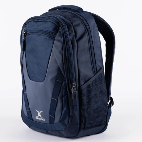 The Gilbert Club V4 Rucksack Backpack by Gilbert is a navy blue bag with zippered compartments, mesh side pockets, top handle, and shoulder straps, shown against a plain white background.