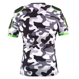 The XP 100 Protective Body Armour - Camo Edition by Gilbert features a black, white, and gray camo pattern with green shoulder/elbow patches and green sleeve trim—back view. Inspired by classic Gilbert protective body armour designs.