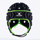 The Gilbert Octane Headguard is a black and green padded rugby scrum cap featuring the Gilbert logo on the front. Designed with custom fit protective padding for enhanced safety, this reliable rugby headguard is shown against a plain white background.