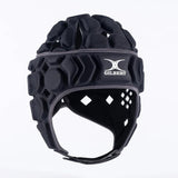 The Gilbert Octane Headguard is a black padded rugby headguard featuring hexagonal EVA padding, a secure chin strap, and the iconic "Gilbert" brand logo on the front. Displayed against a plain white background, this essential piece of protective gear is designed for rugby players.