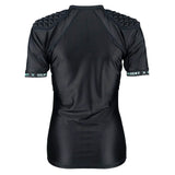 The Women's Triflex V3 Body Armour by Gilbert is a black, short-sleeve athletic shirt featuring padded shoulders for lightweight impact protection in women's rugby. It displays Gilbert branding on the sleeves and is pictured from the back against a white background.